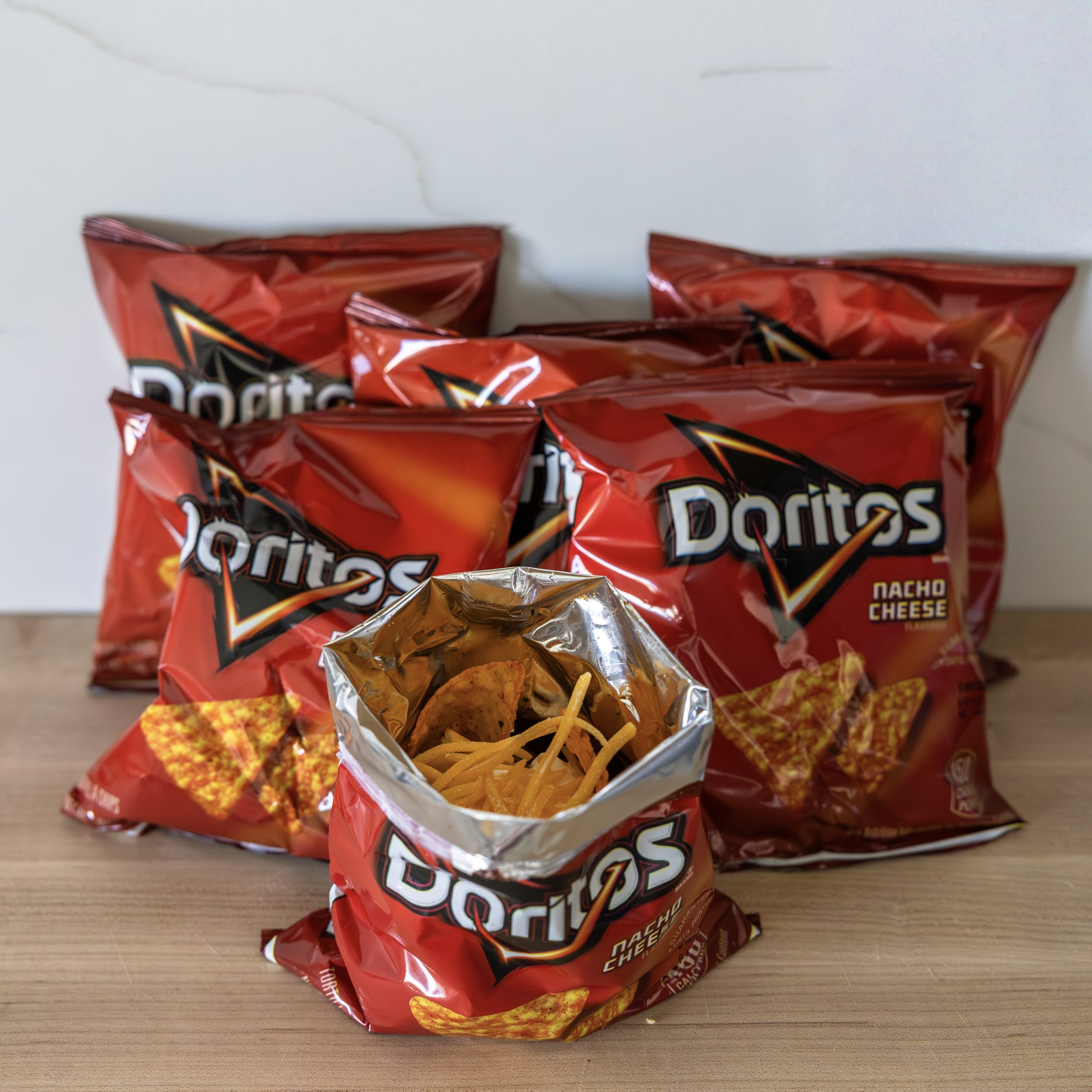 walking taco served in an open Doritos bag filled with seasoned ground beef, lettuce, cheese, and sour cream